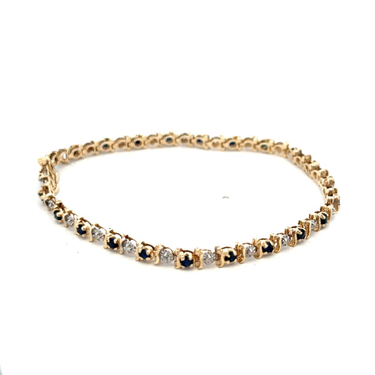 Reeves and Sons 9ct yellow gold sapphire and diamond bracelet with intricate design, weighing 6.5g.