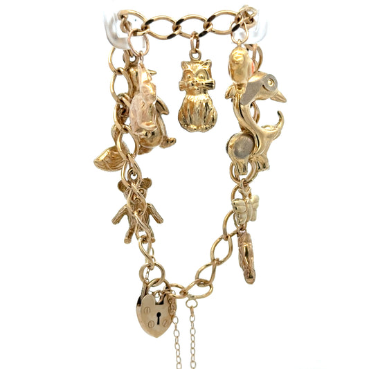 9ct yellow gold charm bracelet weighing 13.4g with intricate details, crafted by Reeves and Sons.