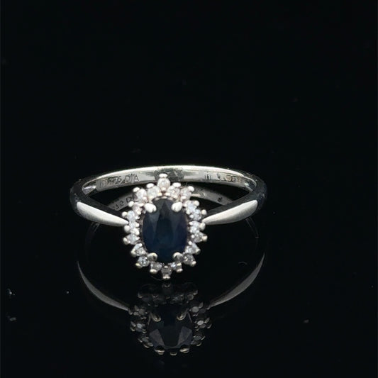 9ct white gold sapphire and diamond ring, size L, with a central sapphire gemstone and diamond accents, by Reeves and Sons.