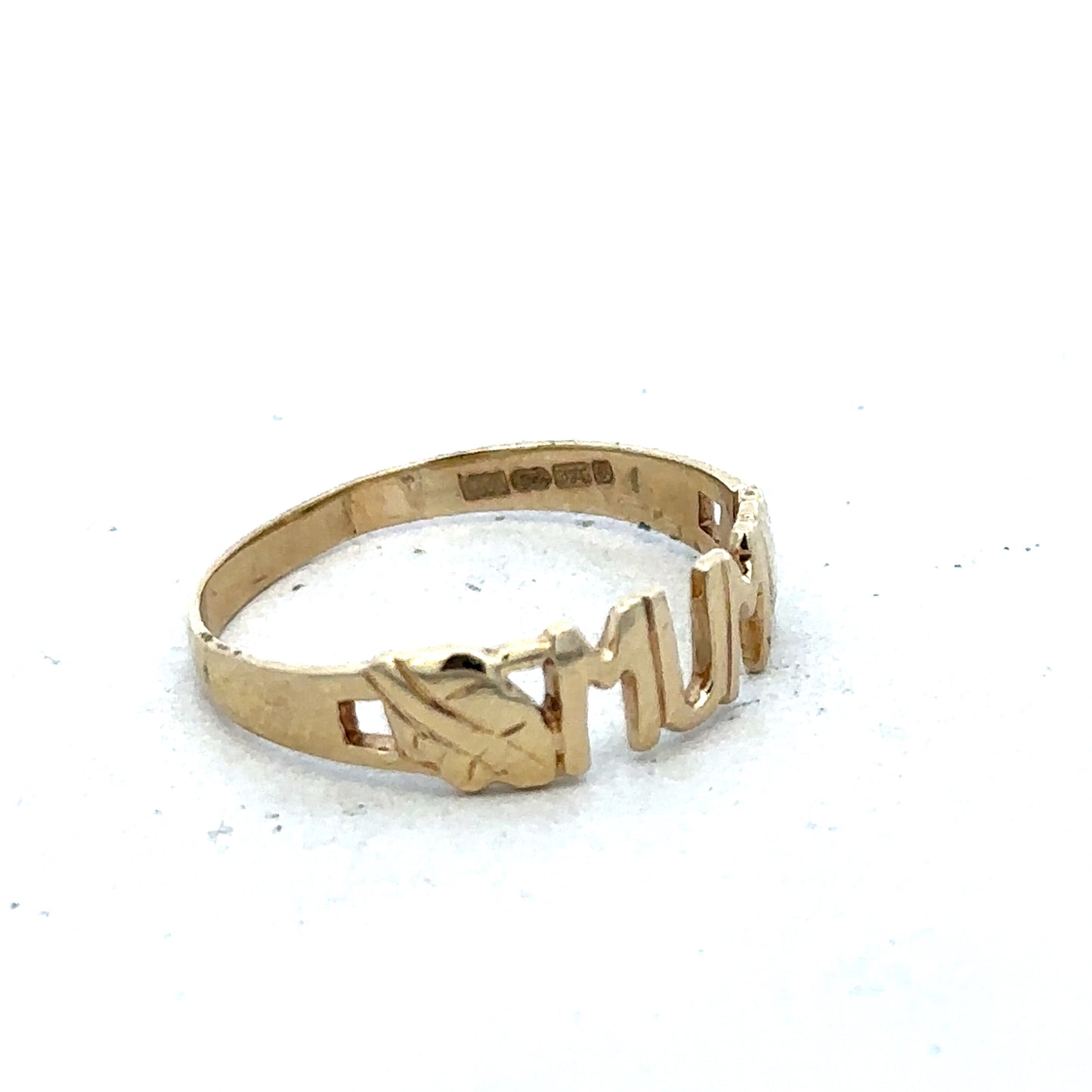 9ct yellow gold MUM ring by Reeves and Sons, size O, featuring a polished band and engraved lettering, on a plain background.
