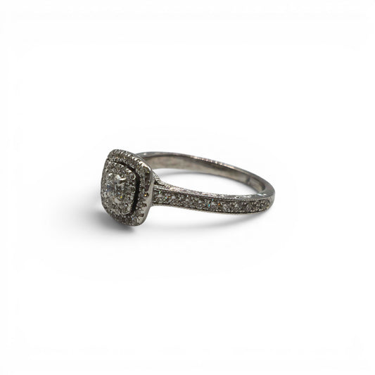 14ct white gold diamond cluster ring by Reeves and Sons with sparkling diamond accents, showcasing elegant jewelry design.