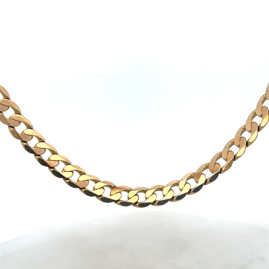 9ct yellow gold curb chain by Reeves and Sons, 47.6g, showcasing its polished links and luxurious shine in a close-up shot.