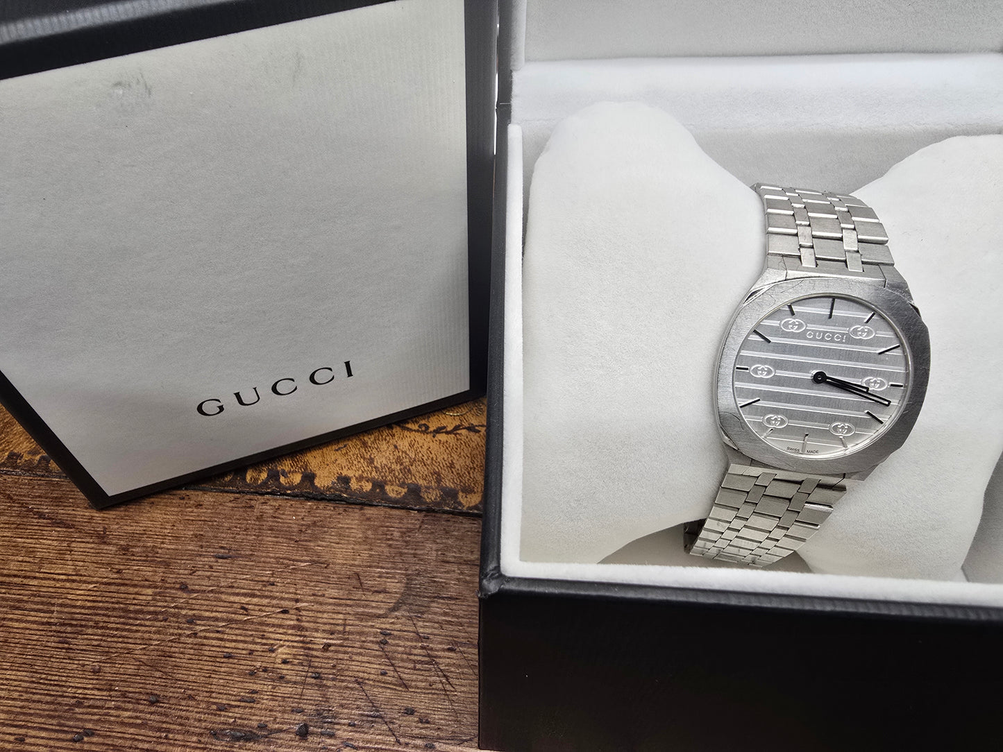 Reeves and Sons ladies Gucci watch box with accompanying paper, elegant storage case for women's wristwatches.