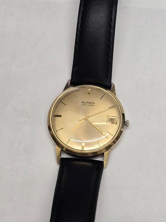 Reeves and Sons Vintage Buren Intra-Matic automatic men's watch with gold plating, sunburst dial, and date display.