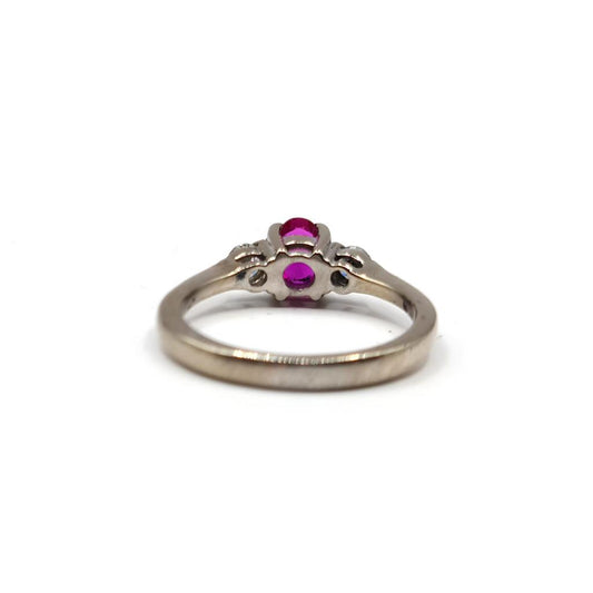 18ct white gold ring featuring a 0.55 carat ruby and 0.20 carat diamonds, elegant jewelry with a polished finish.