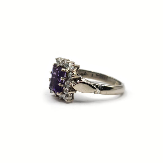 18ct white gold ring with 1.05ct emerald cut amethyst and 0.30ct diamonds, showcasing a elegant gemstone design.