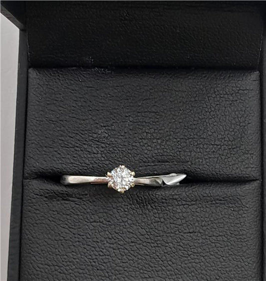18ct white gold diamond ring in size I 1/2 featuring sparkling diamonds on a sleek band.