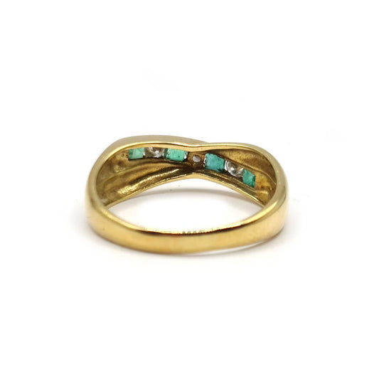 18ct yellow gold emerald and diamond half eternity ring with alternating stones, showcasing elegant and intricate craftsmanship.