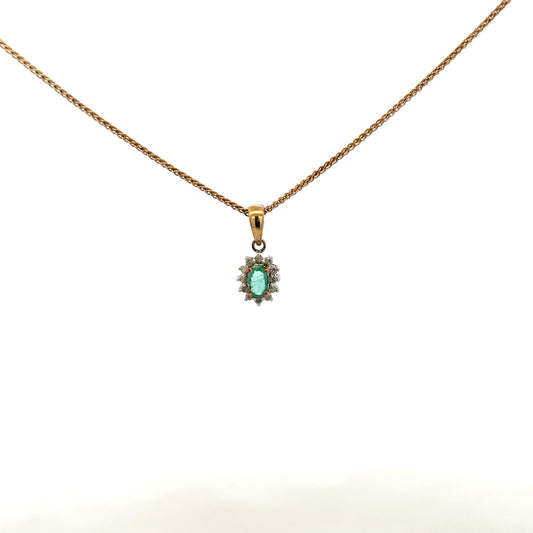 9ct yellow gold chain with emerald and diamond pendant, showcasing a delicate, elegant jewelry piece with vibrant gemstones.