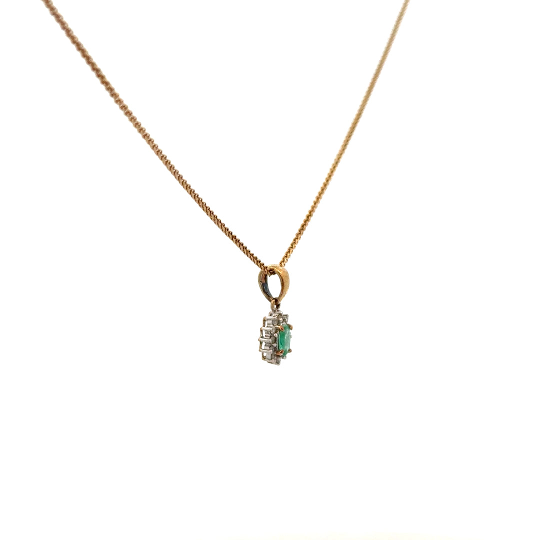 9ct yellow gold chain with emerald and diamond pendant, showcasing a delicate jewelry piece with vibrant green and sparkling gemstones.
