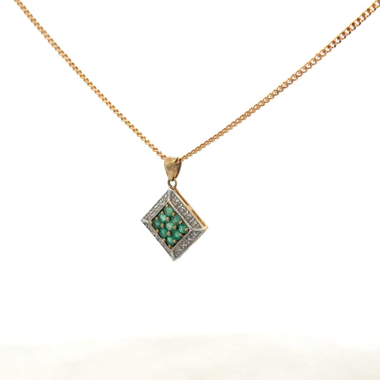 9ct yellow gold chain with emerald and diamond pendant, showcasing a detailed, elegant jewelry piece with vibrant gemstones.