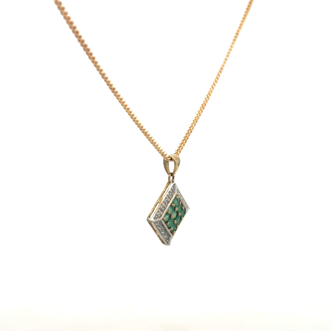 9ct yellow gold chain with emerald and diamond pendant, showing the elegant jewelry piece with detailed gemstones.