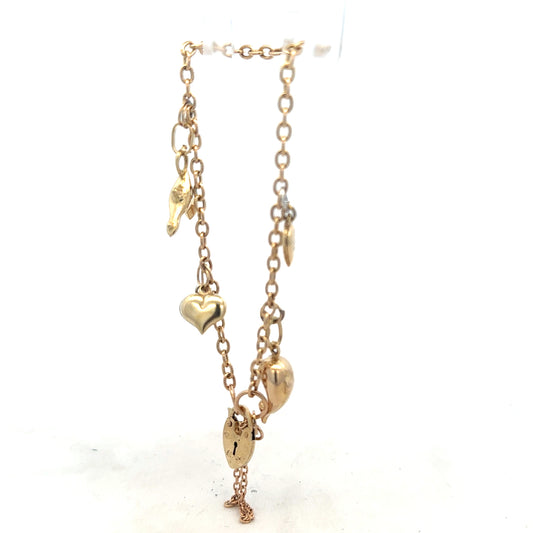 9ct yellow gold charm bracelet weighing 5.4g, unbranded, featuring delicate gold charms and fine chain detail.