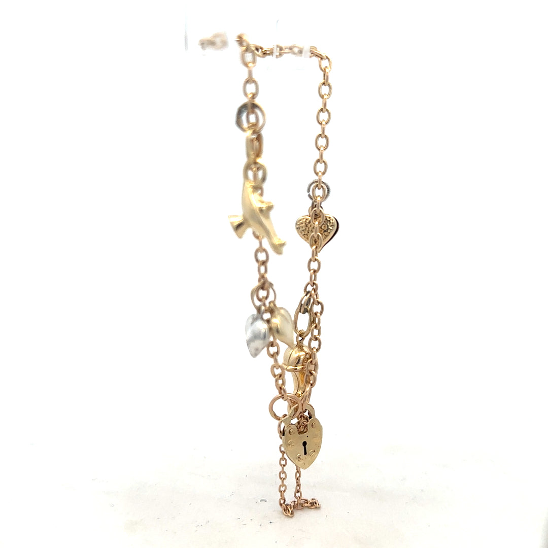 9ct yellow gold charm bracelet with decorative charms, unbranded, weighing 5.4g, shown on a neutral background.