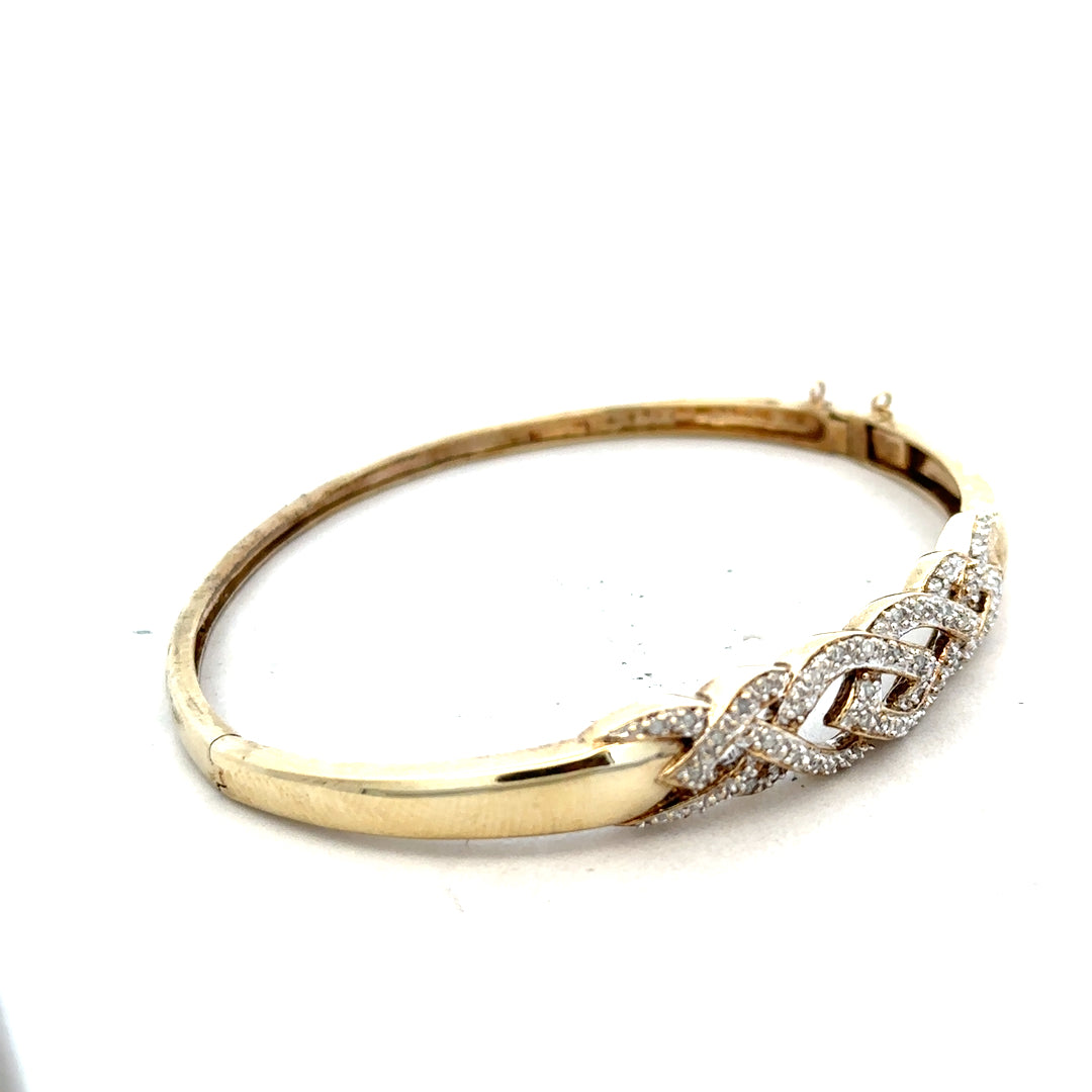 9ct yellow gold diamond bangle bracelet with a sleek design, weighing approximately 10 grams, unbranded jewelry accessory.