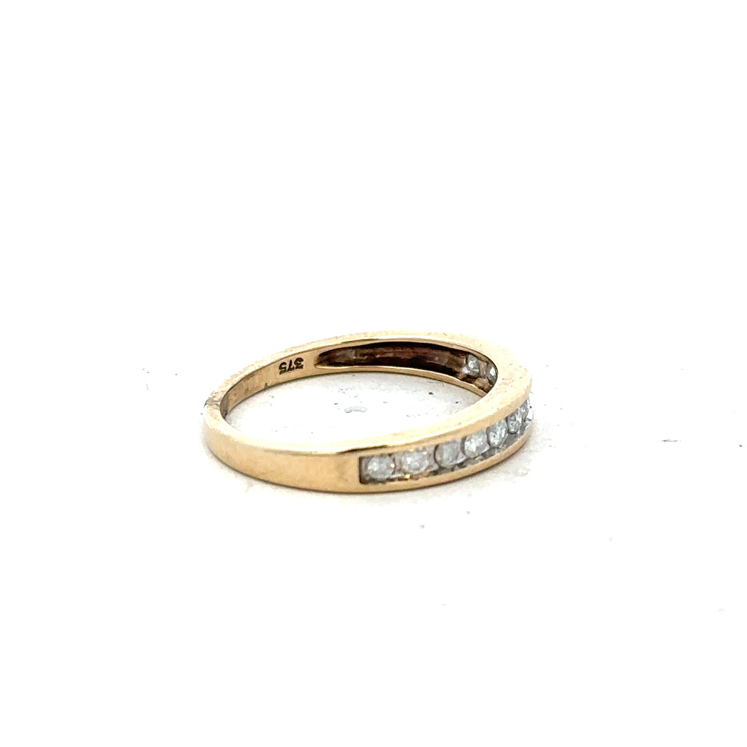 9ct yellow gold diamond ring in size P1/2 with sparkling diamonds, showcasing elegant jewelry design.
