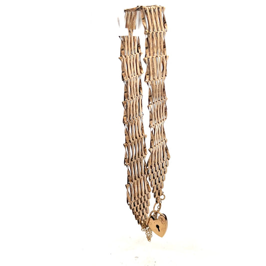 9ct yellow gold gate bracelet showcasing a classic linked chain design, unbranded, weighing 7.4 grams.