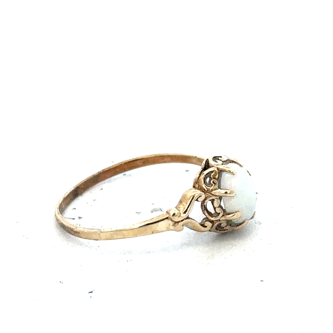 9ct yellow gold opal ring in size P with a vibrant, polished opal gemstone set in a simple gold band.