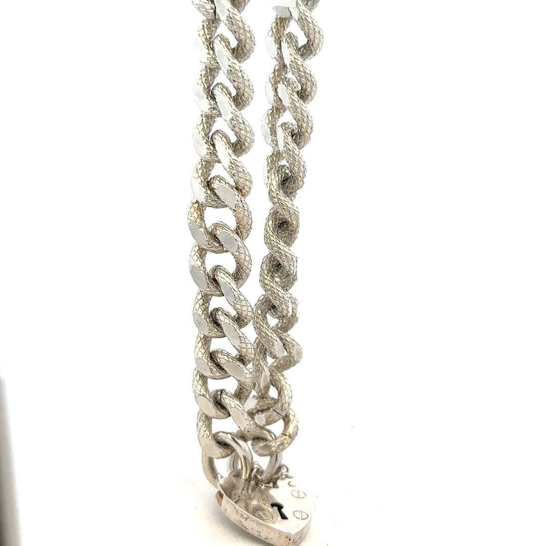 Silver bracelet weighing 64.4g with intricate design, unbranded jewelry accessory, displayed against a neutral background.