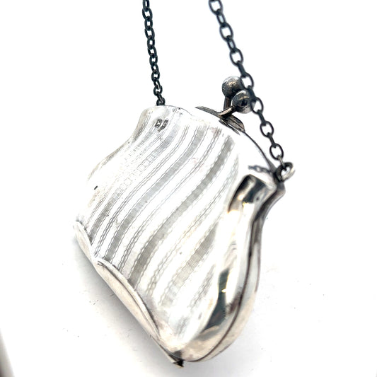 Silver purse pendant weighing 66.2g, unbranded, with intricate details, designed as a jewelry accessory.