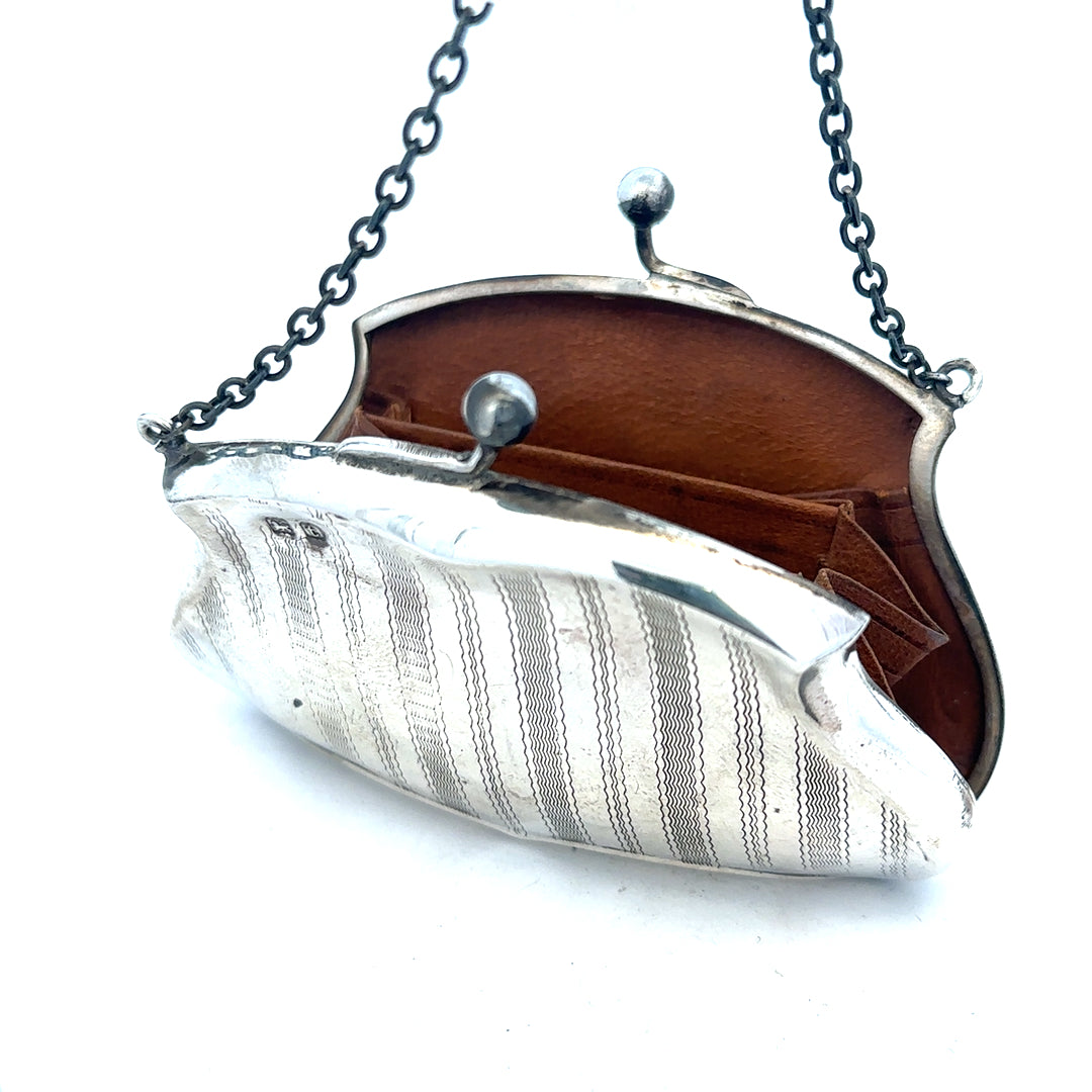 Silver purse pendant weighing 66.2g, unbranded jewelry accessory with detailed design, displayed on a plain background.
