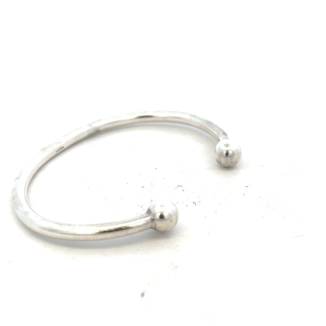 Silver torque bangle bracelet, 20g, unbranded, with a sleek, polished design shown on a neutral background.