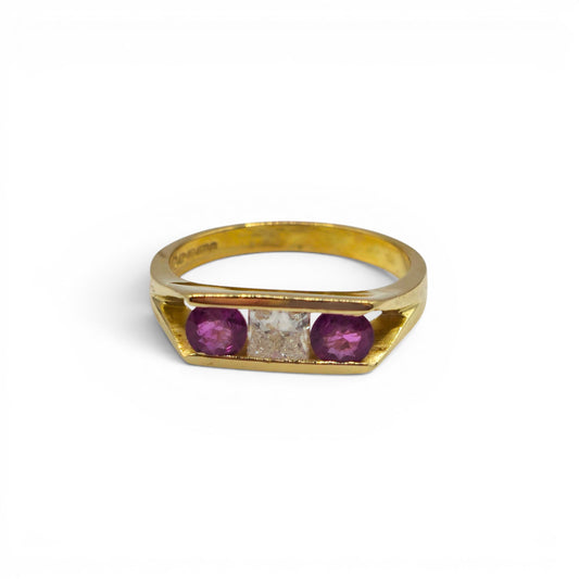 18ct yellow gold ruby and diamond ring by Reeves and Sons, showcasing a central ruby surrounded by sparkling diamonds.