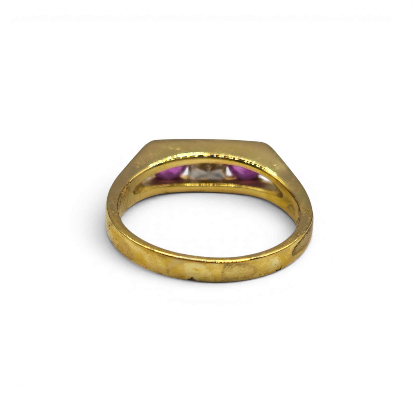 18ct yellow gold ruby and diamond ring by Reeves and Sons featuring a central ruby surrounded by sparkling diamonds.