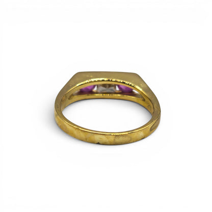 18ct yellow gold ruby and diamond ring by Reeves and Sons featuring a central ruby surrounded by sparkling diamonds.