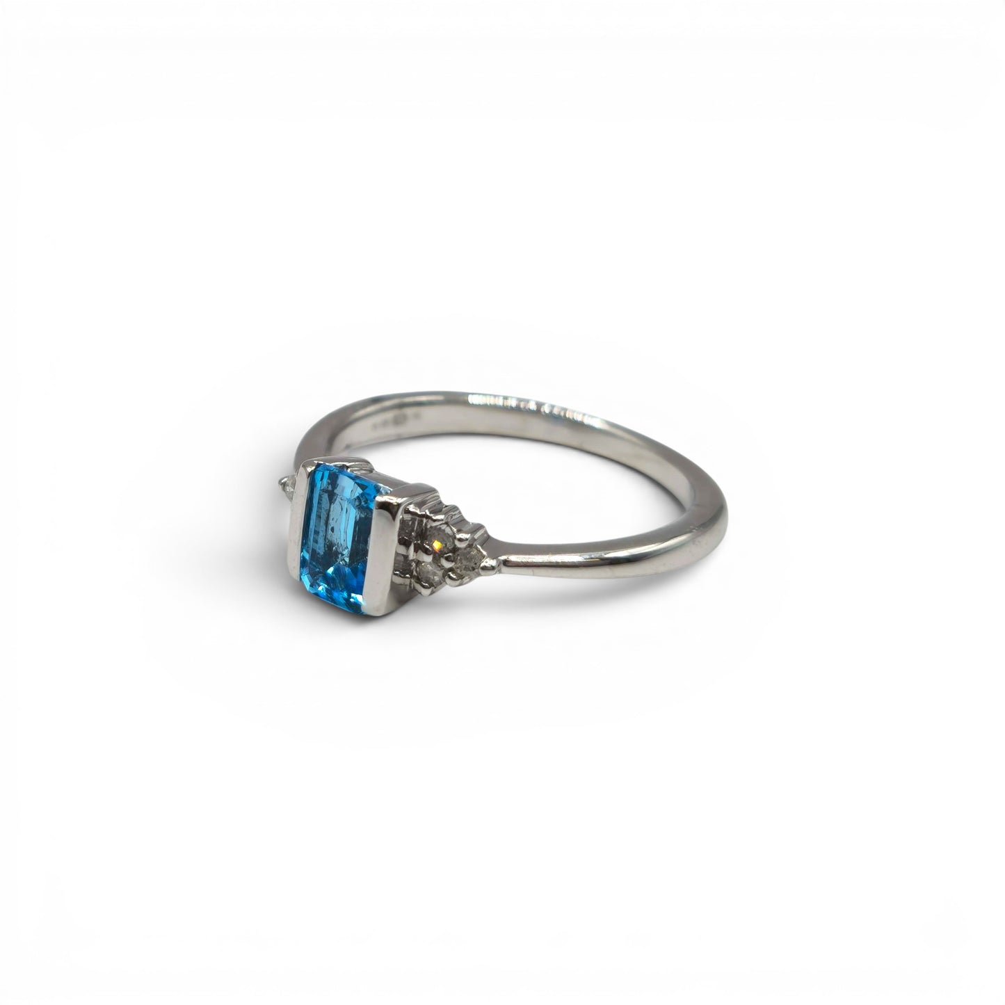 9ct white gold topaz and diamond ring by Reeves and Sons, featuring a large blue topaz gemstone and sparkling diamonds.