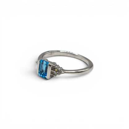 9ct white gold topaz and diamond ring by Reeves and Sons, featuring a large blue topaz gemstone and sparkling diamonds.