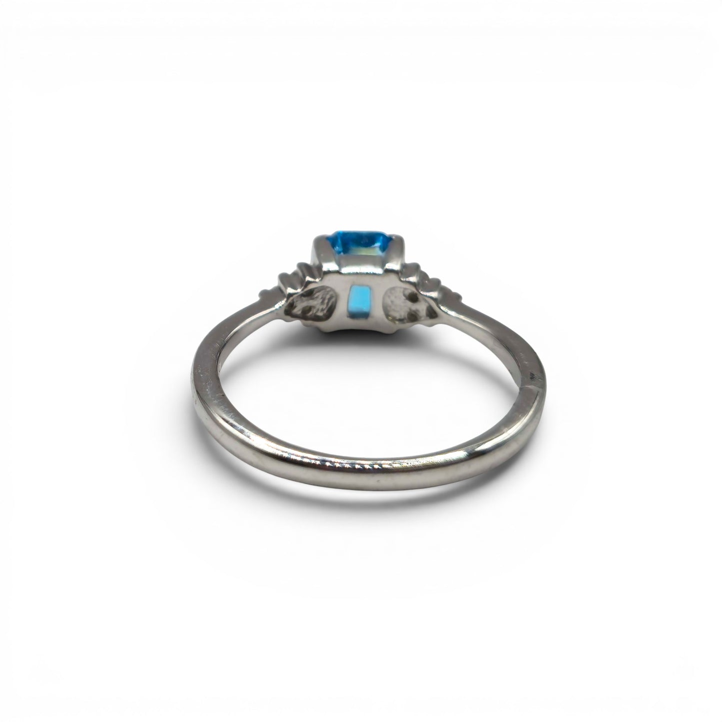 9ct white gold ring with blue topaz and diamond accents, elegant jewelry piece by Reeves and Sons.