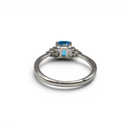 9ct white gold ring with blue topaz and diamond accents, elegant jewelry piece by Reeves and Sons.