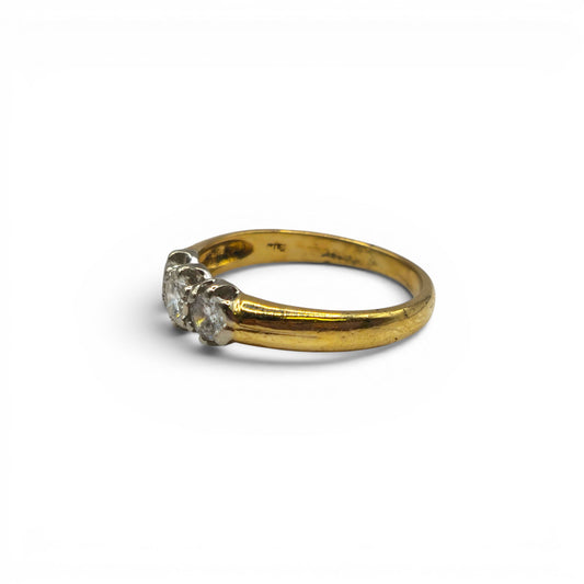18ct yellow gold three stone diamond ring by Reeves and Sons with sparkling diamonds and elegant design.
