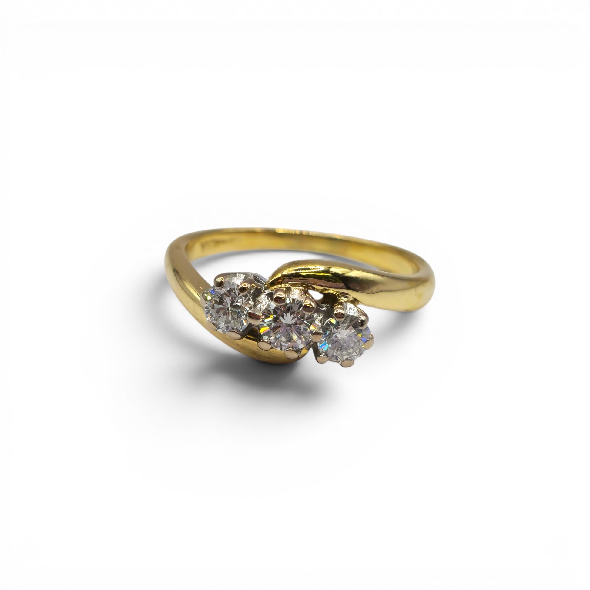 18ct yellow gold diamond twist ring by Reeves and Sons, featuring a delicate band with sparkling diamonds.