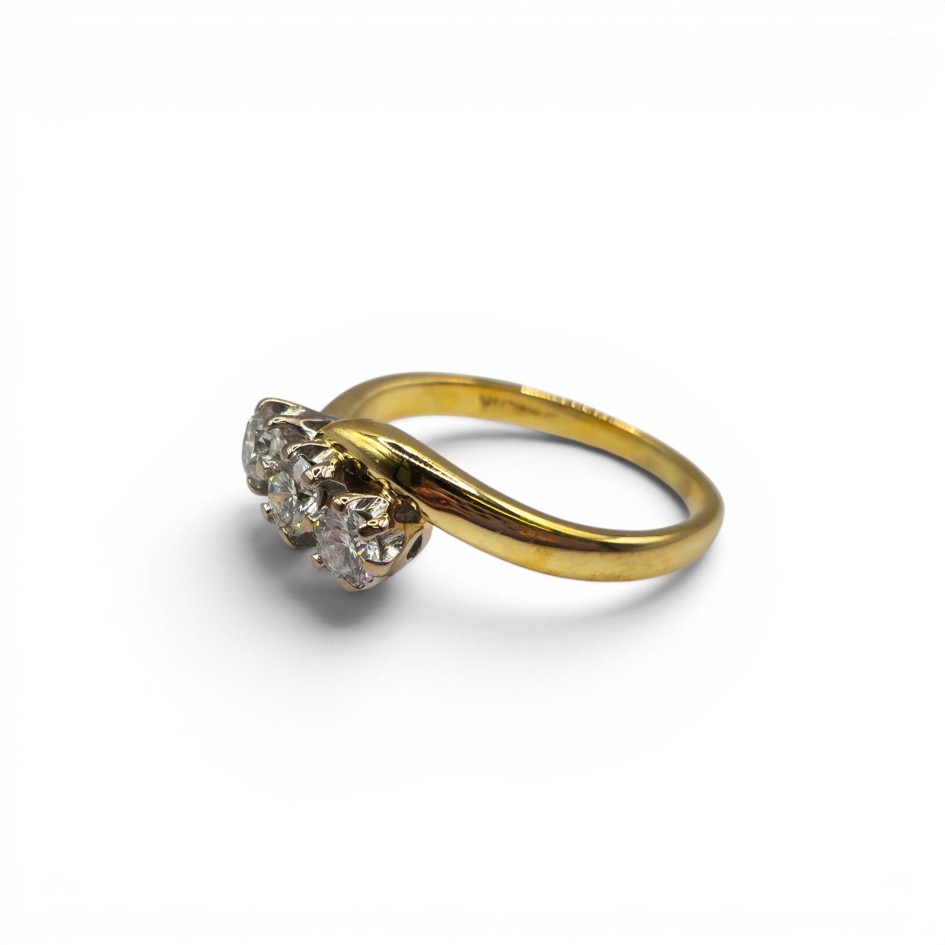 18ct yellow gold diamond twist ring by Reeves and Sons, featuring a delicate design with sparkling diamonds.
