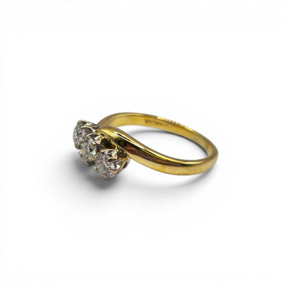 18ct yellow gold diamond twist ring by Reeves and Sons, featuring a delicate design with sparkling diamonds.