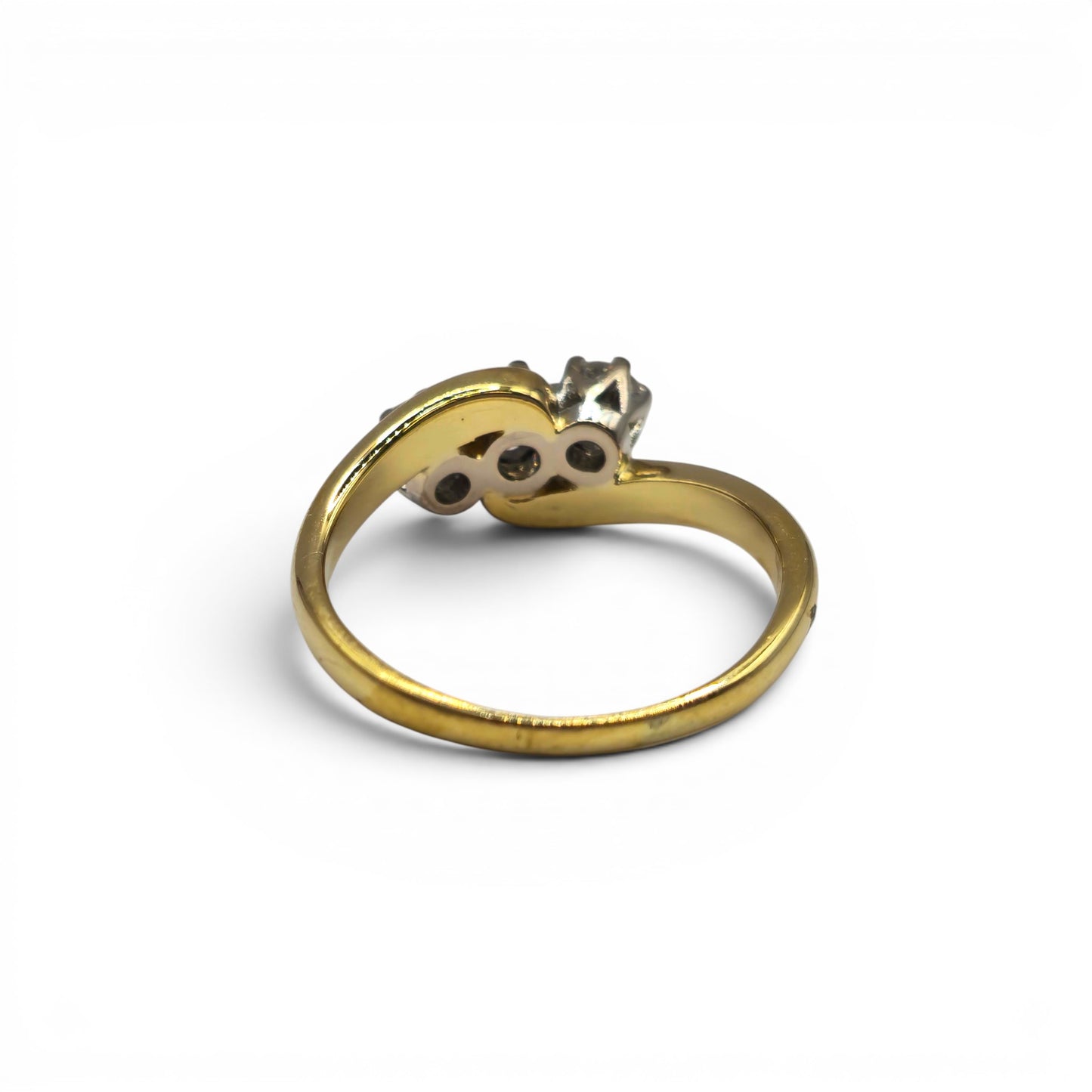 18ct yellow gold diamond twist ring by Reeves and Sons, featuring a sleek design with sparkling diamonds.