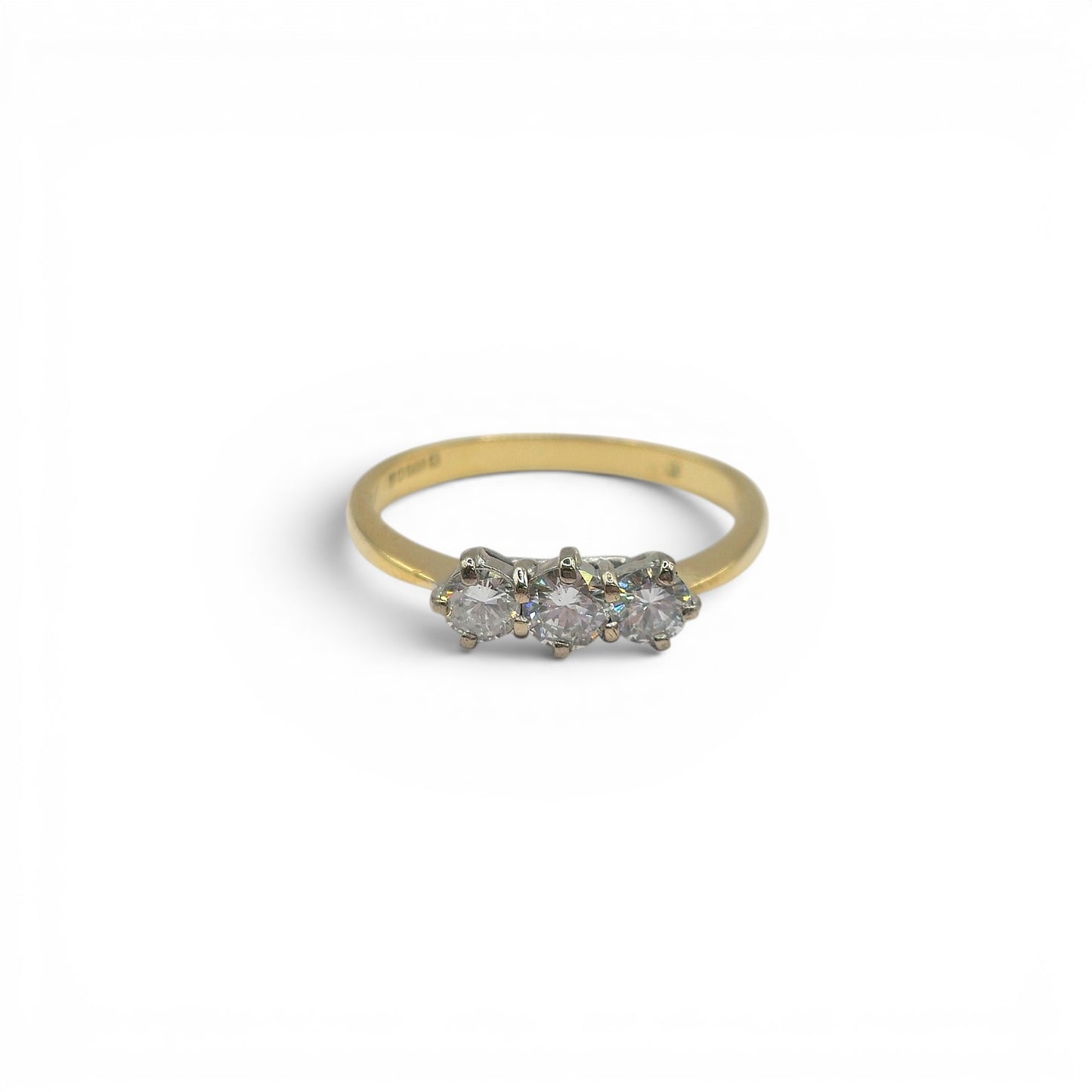 18ct yellow gold three stone diamond ring by Reeves and Sons, featuring sparkling diamonds set in a classic design.