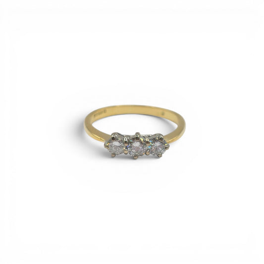 18ct yellow gold three stone diamond ring by Reeves and Sons, featuring sparkling diamonds set in a classic design.