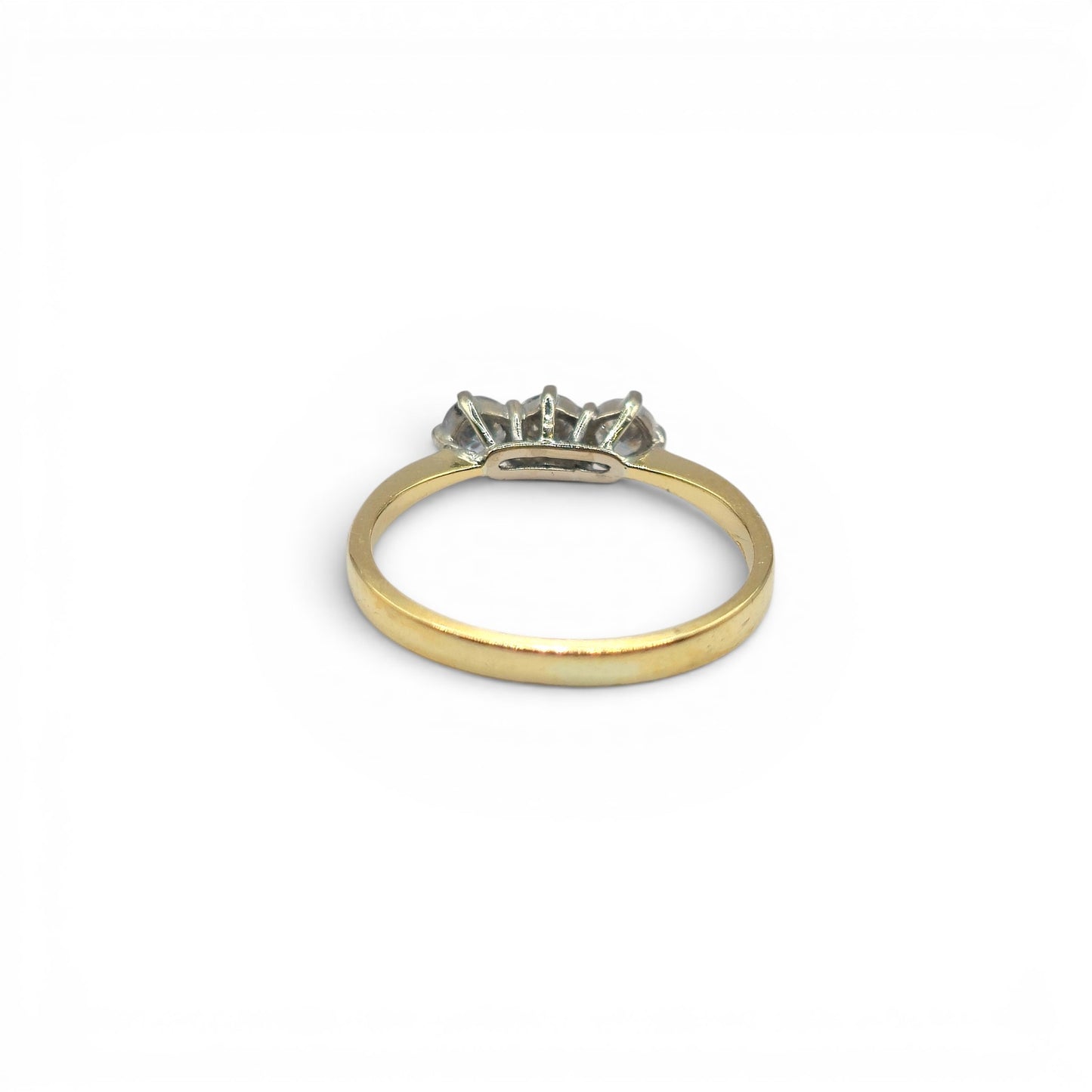 18ct yellow gold three-stone diamond ring by Reeves and Sons, showcasing a elegant design with sparkling diamonds.
