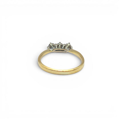 18ct yellow gold three-stone diamond ring by Reeves and Sons, showcasing a elegant design with sparkling diamonds.