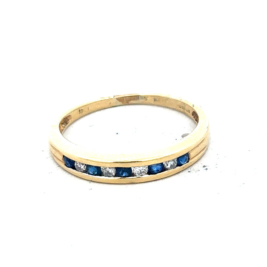 18ct yellow gold sapphire and diamond ring, size S, featuring a central blue sapphire surrounded by sparkling diamonds.