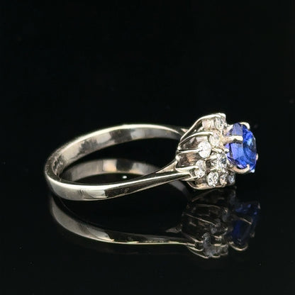 18ct white gold diamond and tanzanite ring, size O, featuring a sparkling central tanzanite gemstone and intricate gold band detail.