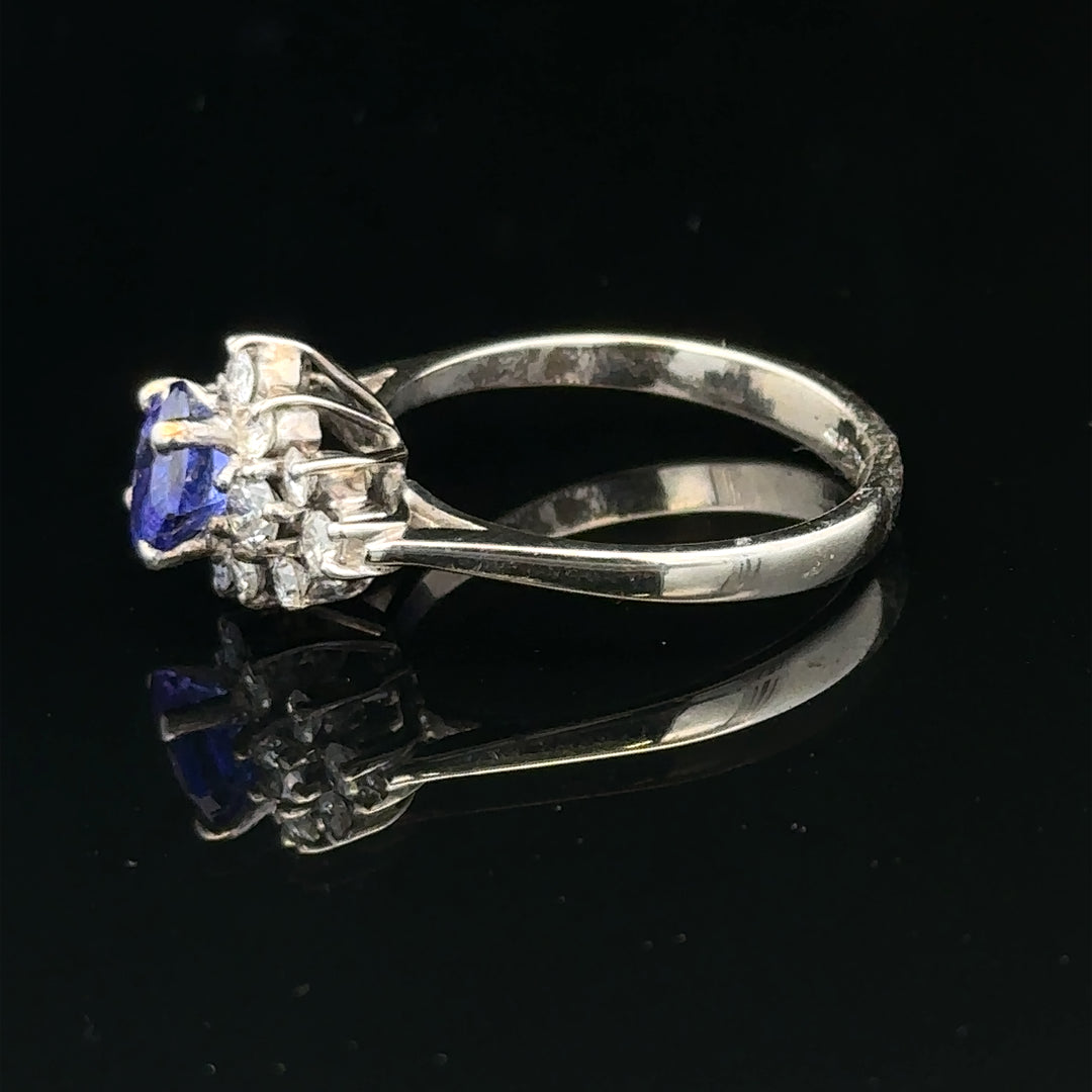 18ct white gold ring with diamond and tanzanite gemstone, size O, featuring a detailed design with sparkling stones.