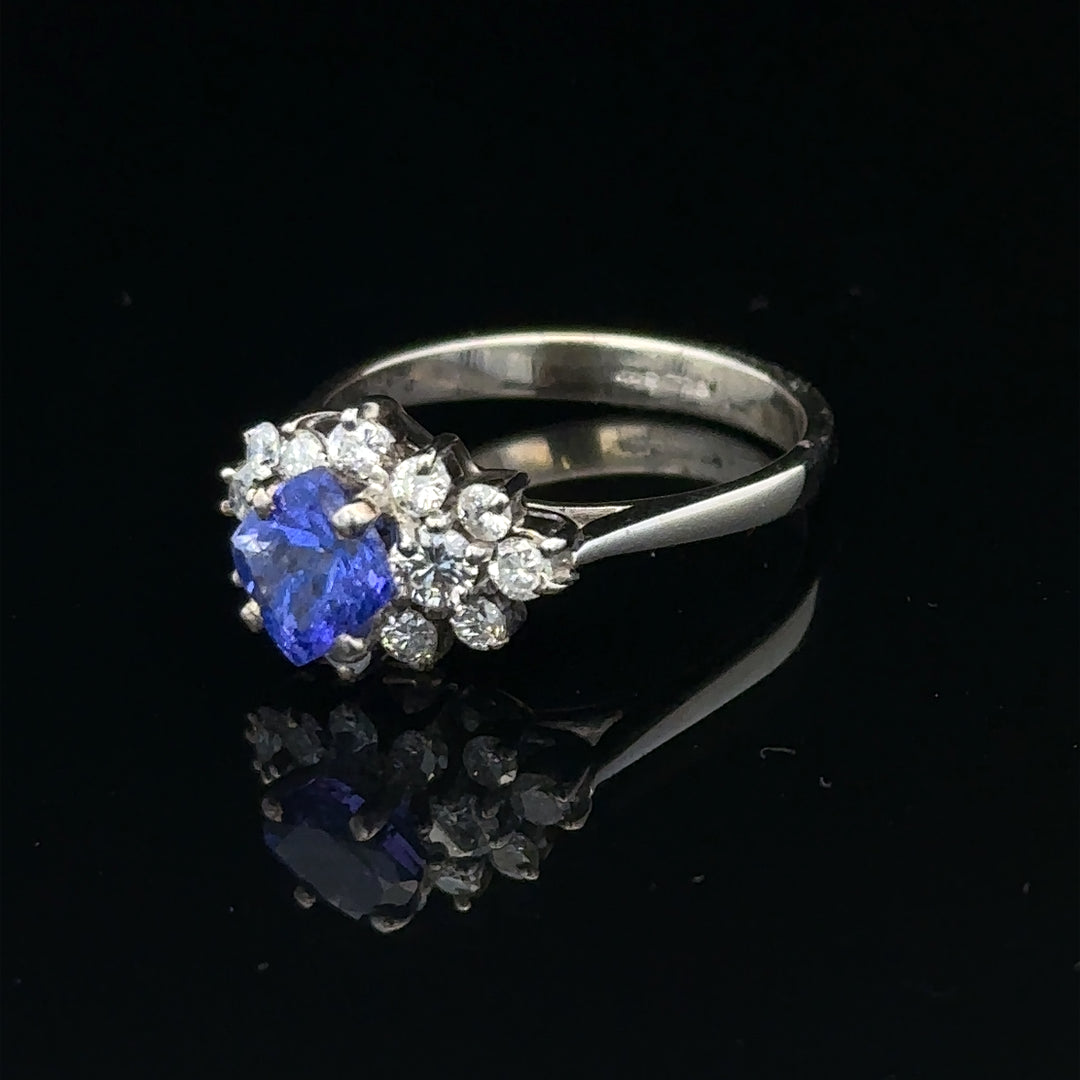 18ct white gold diamond and tanzanite ring in size O, featuring a sparkling gemstone design and elegant craftsmanship.