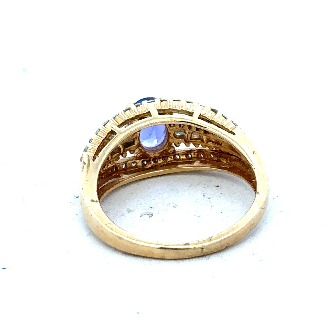 18ct yellow gold diamond and tanzanite ring, size N1/2, featuring a sparkling gemstone design on a sleek gold band.