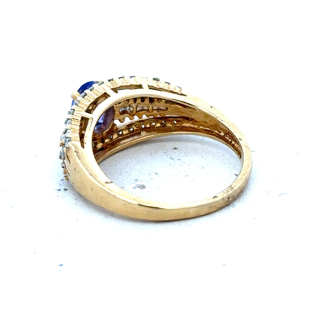 18ct yellow gold diamond and tanzanite ring in size N1/2 with sparkling gemstones and elegant design.