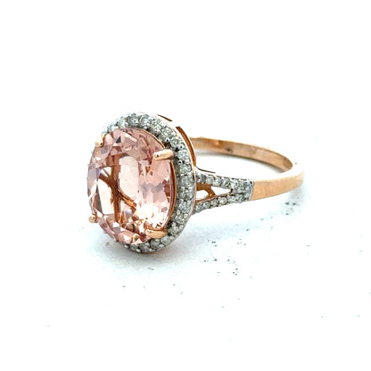14ct gold Morganite and diamond ring in size S, featuring a sparkling gemstone centerpiece and intricate band design.