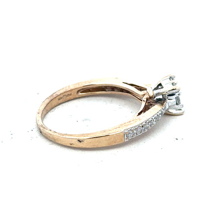 9ct yellow gold diamond ring size P with sparkling stones, unbranded jewelry, shown on a plain background.